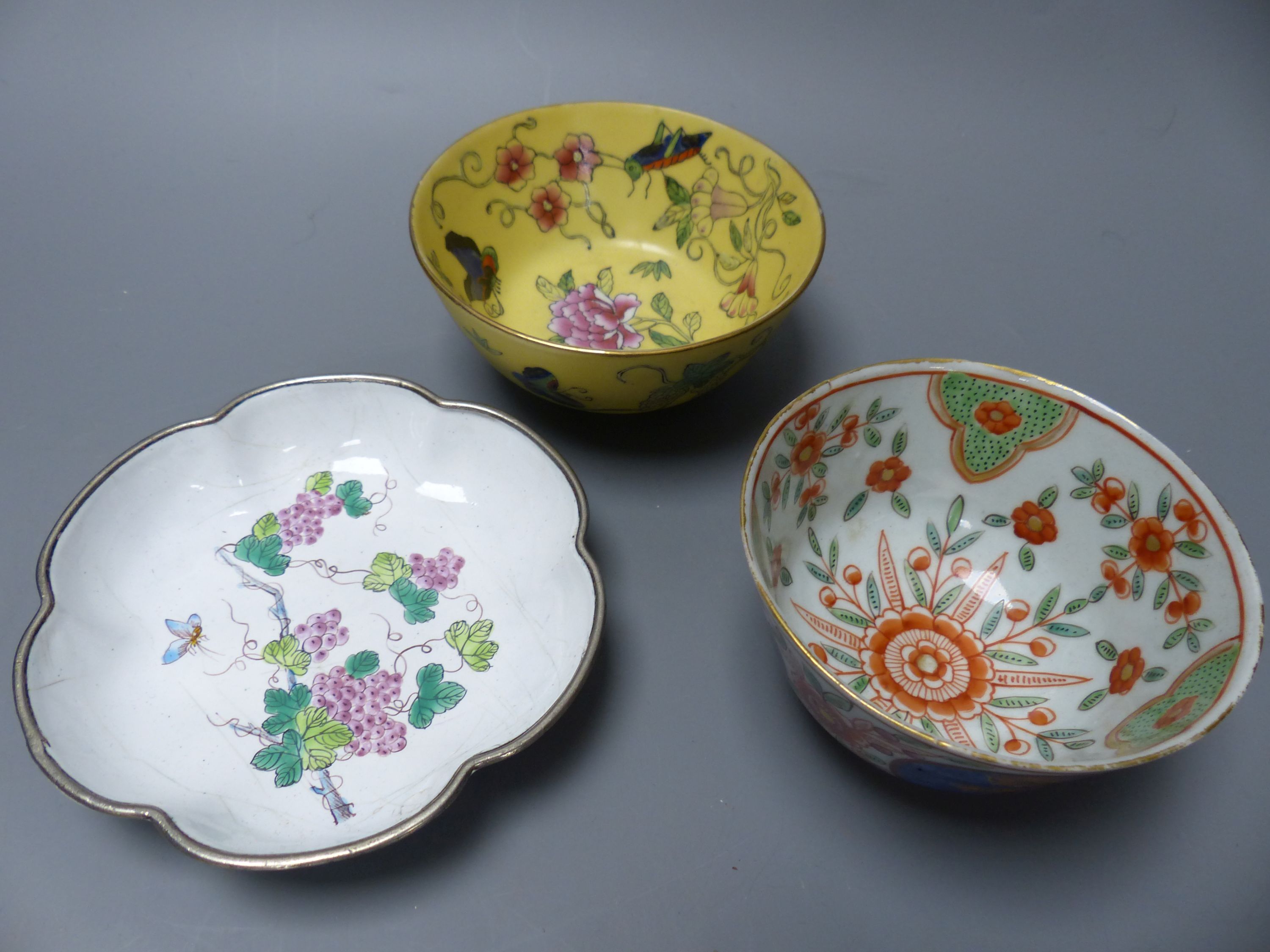 A carved jade mouse on associated hardwood stand, three pieces of Oriental porcelain including an enamel dish and two tea bowls, larges